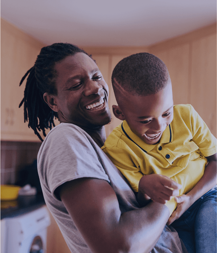 Father and son playing in their home.