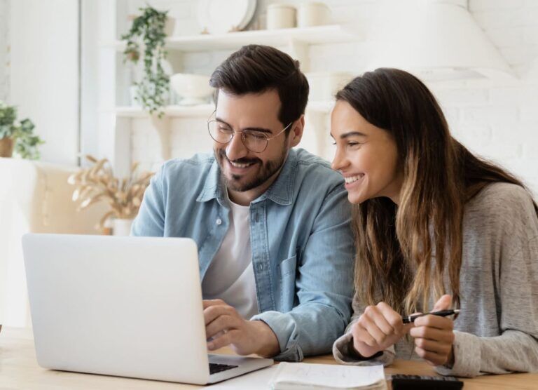 Two people using a shared laptop.